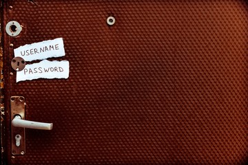 The old entrance door to the apartment. On the door glued two pieces of paper with inscriptions.
