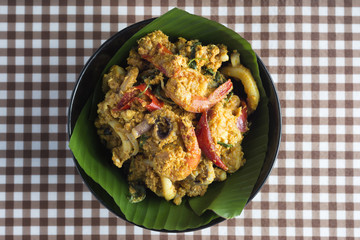 steamed fish with curry paste on brown Table stripes.