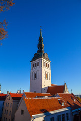 Obraz premium Sunny summer day and Old Medieval Former St. Nicholas Church - Niguliste In Tallinn, Estonia