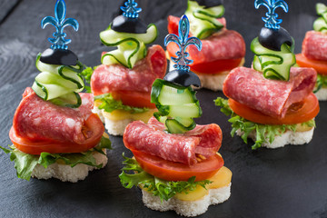 Canape on skewers with vegetables and sausage