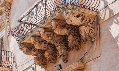 View of the stone balcony Baroque in Noto, Sicily