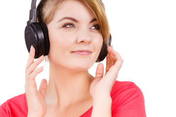 Naklejka premium Woman in big headphones listening music isolated