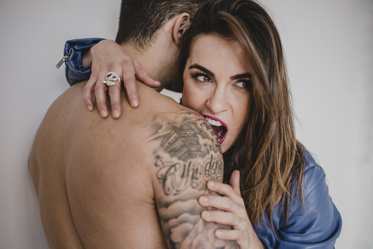 Woman biting man's shoulder