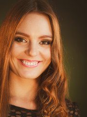 Fototapeta premium Happy woman curling her long brown hair