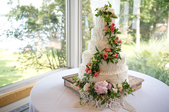 Decorated wedding cake on wooden cake stand