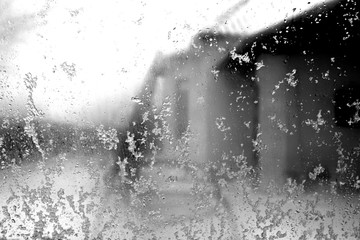 Window in snow with blur effect in black and white