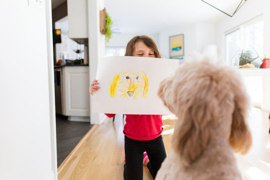 Child showing dog portrait 