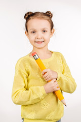 female child holding huge pen