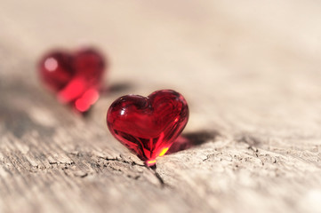 two valentines red hearts on a wooden table , love concept with copy space background