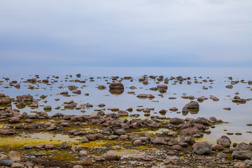 Beautiful cloudy landscape of rocky sea shore. Tranquil scene of Baltic sea.