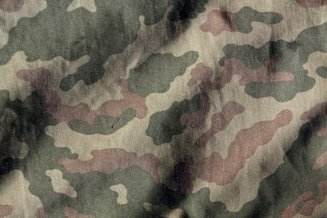 Weathered camouflage cloth texture. © pavelalexeev