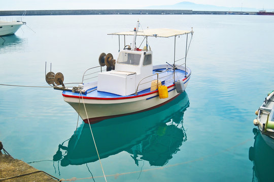 fishing boat reflected on sea at Kalamata port Peloponnese Greece
