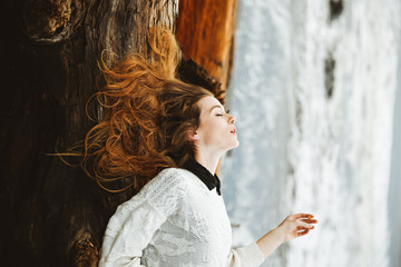 Woman lying on a log on a beach