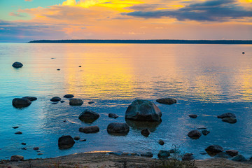 Sunrise over the sea. Stone on the foreground