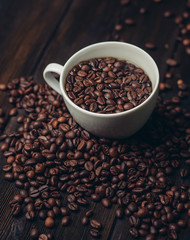 coffee beans in a mug and on a table