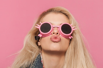 Barbie pop girl portrait wearing odd sunglasses and kissing