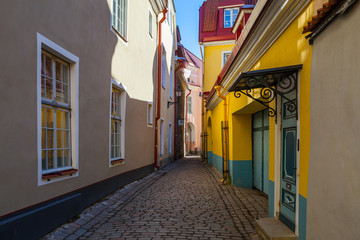 Fototapeta na wymiar Narrow street with colorful houses in old town. Tallinn, Estonia