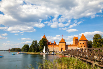 Naklejka na ściany i meble Tourists visit Trakai castle in sunny siummer day, nice time to have boat trip. Long exposure, motion blur