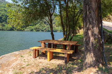 Fototapeta premium Picnic bench table by the river