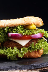 Tasty grilled prawn and beef burger with lettuce and tomato