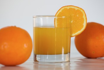 orange juice and two oranges