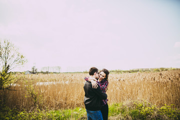 Portrait of a young couple on a background of reeds.