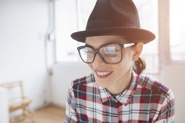 hipster style woman with computer screen reflecting on her vintage glasses