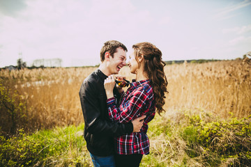 Portrait of a young couple on a background of reeds.