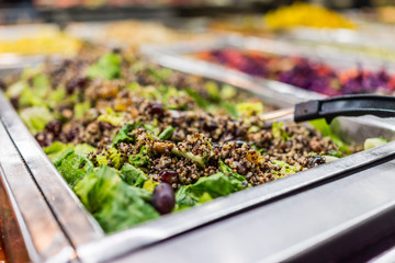 Quinoa salad with lettuce in bar with spoon