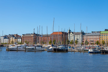 Scenic summer view of the Old Port pier architecture with ships, yachts and other boats in the Old Town of Helsinki, Finland