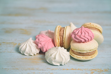 french macaroons and meringues on wood background  wiyh copyspace