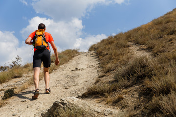 Young guy walking up mountain