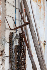 Old pitch fork and chains on the brick wall