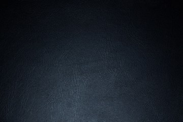 black paper texture or background with spotlight, dark tone 