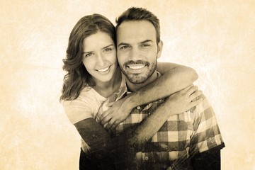Composite image of happy young couple embracing