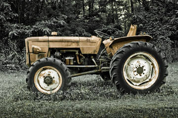 Fototapeta na wymiar Rusty tractor abandoned in a field