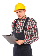 young worker with yellow helmet and gloves, writes in the book