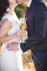 Bride and groom with champagne glasses in wedding day