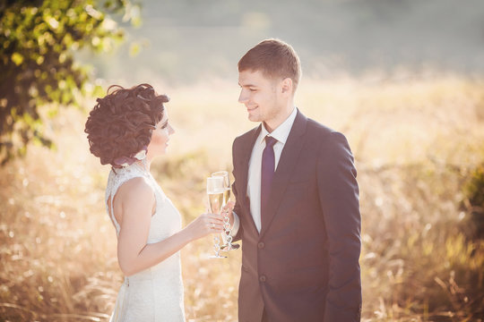 Toned wedding photo, bride and groom with champagne