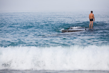 the lone man in the sea reflects