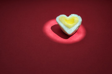 Egg heart on red. Romantic background concept