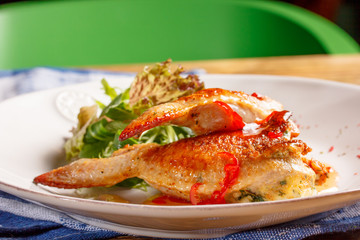 Fried chicken with chilli and lettuce on the plate.