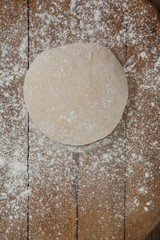 Pizza dough and flour on rolling board