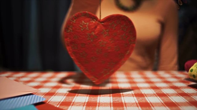 Female holding heart pendulum in hands, weak broken love symbol hd