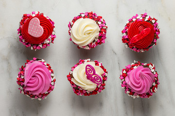 Many cupcakes with hearts on white marble
