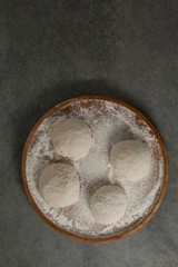 Pizza dough and flour on rolling board