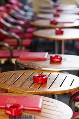 Vacant cafe street tables with ashtrays