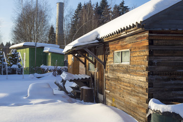 Wooden barn and cabins on cold winter day at minus 27 degree Celsius