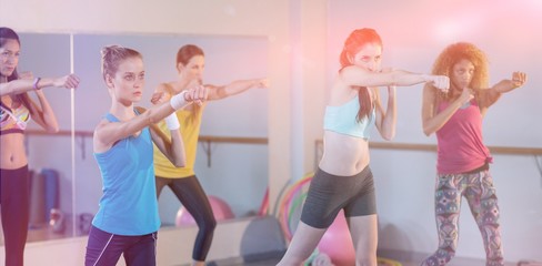 Fototapeta na wymiar Group of women exercising on aerobic stepper