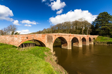 Fototapeta na wymiar Bredwardine Bridge, red brick crossing river Wye